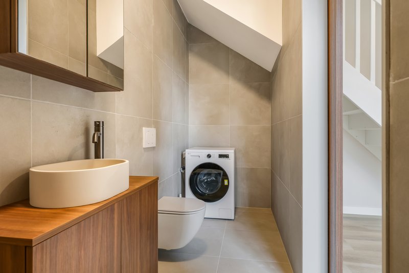Badkamer van appartement 188 met wastafel, toilet en wasmachine